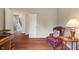 Comfortable living room with hardwood floors, a desk, a lamp, and view to the hallway at 1029 Bridgeport Dr, Westfield, IN 46074