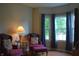 Comfortable sitting area with two chairs, a small table, and bright windows with blue curtains at 1029 Bridgeport Dr, Westfield, IN 46074
