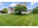 Spacious, well-manicured lawn with mature trees adding to the home's curb appeal at 1029 Bridgeport Dr, Westfield, IN 46074