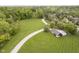 Aerial view of property with long driveway and barn, surrounded by lush trees at 10627 Indian Lake S Blvd, Indianapolis, IN 46236
