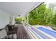 Relaxing back porch with comfortable seating overlooking the pool and lush landscaping at 10627 Indian Lake S Blvd, Indianapolis, IN 46236
