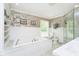 Spa-like bathroom with a large soaking tub, separate shower, and elegant fixtures at 10627 Indian Lake S Blvd, Indianapolis, IN 46236