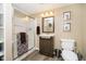 Neutral toned bathroom featuring a glass enclosed shower, wood vanity, and modern fixtures at 10627 Indian Lake S Blvd, Indianapolis, IN 46236