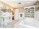 Bright bathroom with tiled floor, double vanity sinks, a soaking tub, and lots of natural light at 10627 Indian Lake S Blvd, Indianapolis, IN 46236