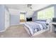 Bright bedroom with blue walls and a ceiling fan, plus a cozy window seat area at 10627 Indian Lake S Blvd, Indianapolis, IN 46236
