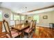 Formal dining room showcasing hardwood floors, large table, and stylish chandelier at 10627 Indian Lake S Blvd, Indianapolis, IN 46236