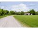 Long gravel driveway leading to the barn on a green manicured lawn at 10627 Indian Lake S Blvd, Indianapolis, IN 46236