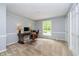 Comfortable home office with a large window, neutral colors, carpet, and a stylish desk at 10627 Indian Lake S Blvd, Indianapolis, IN 46236