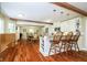 Bright open kitchen featuring a breakfast bar, island, stainless steel appliances, and a seamless flow into the dining area at 10627 Indian Lake S Blvd, Indianapolis, IN 46236