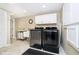 Laundry room featuring modern washer and dryer, white cabinets, and utility sink at 10627 Indian Lake S Blvd, Indianapolis, IN 46236