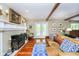 Cozy living room with fireplace, French doors to the exterior, hardwood floors and an abundance of natural light at 10627 Indian Lake S Blvd, Indianapolis, IN 46236