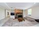 Basement living room with a stone fireplace, built-in shelving and neutral colors at 10627 Indian Lake S Blvd, Indianapolis, IN 46236