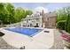 Resort-style backyard featuring a sparkling pool and ample lounge seating at 10627 Indian Lake S Blvd, Indianapolis, IN 46236
