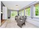 Sunroom featuring tiled floors, many windows, and access to the backyard at 10627 Indian Lake S Blvd, Indianapolis, IN 46236