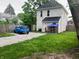 Exterior of home with a large gravel parking area and fenced in yard at 1114 N Olney St, Indianapolis, IN 46201