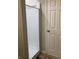 Bathroom featuring a standing shower with sliding door and a modern, white door at 1114 N Olney St, Indianapolis, IN 46201