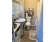 Small, well-lit bathroom with a pedestal sink and daisy-themed decor at 1114 N Olney St, Indianapolis, IN 46201