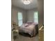 Cozy bedroom features patterned bedding and natural light from the windows at 1114 N Olney St, Indianapolis, IN 46201