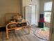Bedroom features light gray walls, wood-look flooring, and a window with natural light at 1114 N Olney St, Indianapolis, IN 46201