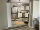 Bright, open kitchen with stainless steel appliances and white cabinetry visible from Living Room at 1114 N Olney St, Indianapolis, IN 46201