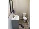 Compact powder room with modern vanity, mirror, and toilet at 1114 N Olney St, Indianapolis, IN 46201