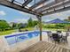 Backyard with a pool, dining set, lounge chairs, and a slide, perfect for outdoor activities and relaxation at 11521 Willow Bend Dr, Zionsville, IN 46077