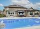 Home exterior showcases backyard pool with diving board, solar panels, pergola, dining area, and well-maintained landscaping at 11521 Willow Bend Dr, Zionsville, IN 46077