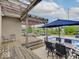 Backyard with a pool, spa, dining area, and a lounging area, under a wooden pergola, set for outdoor enjoyment at 11521 Willow Bend Dr, Zionsville, IN 46077