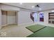 Basement entertainment area featuring a projector, golf simulator, and staircase at 11521 Willow Bend Dr, Zionsville, IN 46077