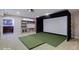 Basement entertainment area featuring a projector, golf simulator, and wet bar at 11521 Willow Bend Dr, Zionsville, IN 46077