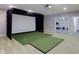 Basement entertainment area with projector and golf simulator at 11521 Willow Bend Dr, Zionsville, IN 46077