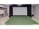 Basement entertainment area with projector and golf simulator at 11521 Willow Bend Dr, Zionsville, IN 46077