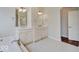 Bathroom with double vanity, decorative mirrors, and ample counter space at 11521 Willow Bend Dr, Zionsville, IN 46077