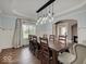 Elegant dining room showcasing a modern chandelier, wainscoting, and dark wood dining set at 11521 Willow Bend Dr, Zionsville, IN 46077