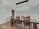 Stately dining room featuring wainscoting and modern chandelier over an expansive dining table at 11521 Willow Bend Dr, Zionsville, IN 46077