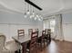 Elegant dining room featuring a modern chandelier, wainscoting and an expansive dining table at 11521 Willow Bend Dr, Zionsville, IN 46077