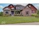 Charming brick home with a manicured lawn and a welcoming front porch at 11521 Willow Bend Dr, Zionsville, IN 46077