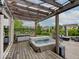 Outdoor hot tub and a seating area covered with wood pergola offers a relaxing experience with backyard views at 11521 Willow Bend Dr, Zionsville, IN 46077