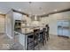 Modern kitchen featuring a large island with seating, stainless steel appliances, and tile flooring at 11521 Willow Bend Dr, Zionsville, IN 46077
