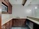 Modern kitchenette featuring dark cabinets, stainless sink, and light granite countertops at 11521 Willow Bend Dr, Zionsville, IN 46077
