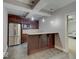 Charming kitchenette with stainless steel appliances and a granite-topped bar for dining at 11521 Willow Bend Dr, Zionsville, IN 46077