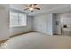 Open living space with ceiling fan and a view to a secondary room at 11521 Willow Bend Dr, Zionsville, IN 46077