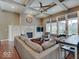 Inviting living room with a fireplace, coffered ceiling, and large windows offering ample natural light at 11521 Willow Bend Dr, Zionsville, IN 46077