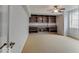 Bright living room featuring built-in shelving and cabinets, and lots of light at 11521 Willow Bend Dr, Zionsville, IN 46077