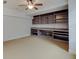 Spacious carpeted living room featuring built-in shelving and a ceiling fan at 11521 Willow Bend Dr, Zionsville, IN 46077