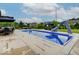 Large backyard pool has a slide, poolside seating, and dining areas, set against a backdrop of well-manicured lawns at 11521 Willow Bend Dr, Zionsville, IN 46077