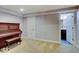 Sitting room featuring a piano with an adjoining bathroom at 11521 Willow Bend Dr, Zionsville, IN 46077