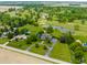 Aerial view showcases the property’s prime location on a golf course with lakes and lush greenery at 11705 N Shelby 700 W, New Palestine, IN 46163