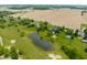 Overhead view showcases the property's sprawling layout with a pond, pool, and golf course nearby at 11705 N Shelby 700 W, New Palestine, IN 46163