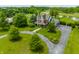 Aerial view of Victorian home with wraparound driveway, mature trees and manicured lawn at 11705 N Shelby 700 W, New Palestine, IN 46163